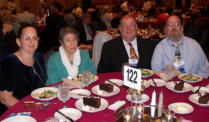 Picture of Mike and Barb Smith with friends Jim and Sue at a round table at the banquet of the National Federation of the Blind Convention in Orlando, Florida in 2013.