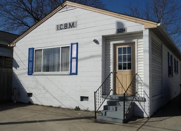 Picture of the white Office Building with blue window shutters and a yellow entrance door.  The Building has the ICBM logo that was located in South Charleston, West Virginia.